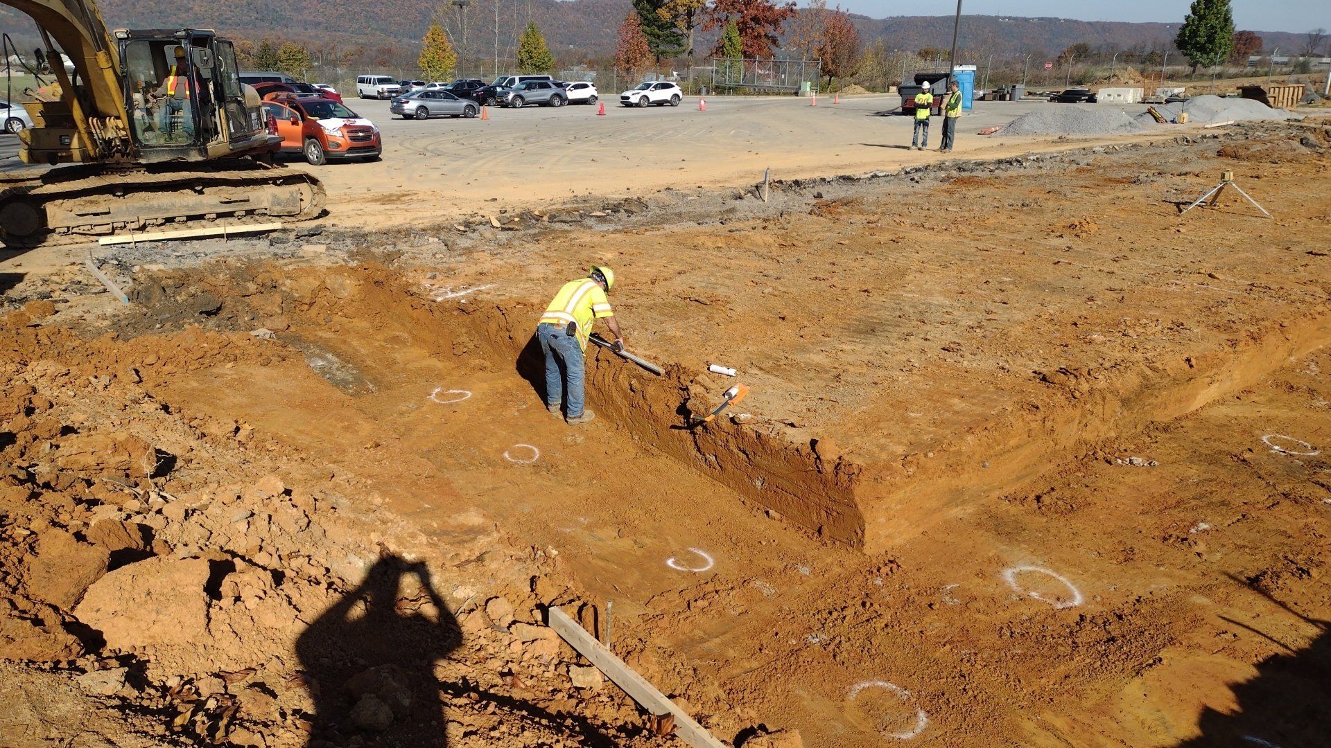 Deep excavation with worker for scale