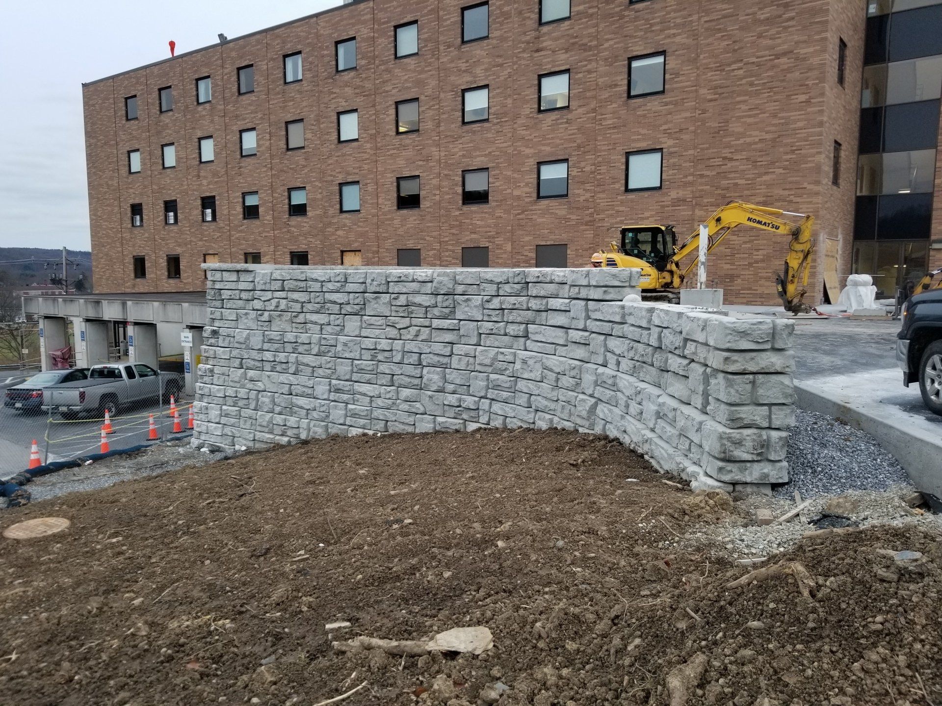 Large segmental retaining wall built by Ameron Construction at a commercial site